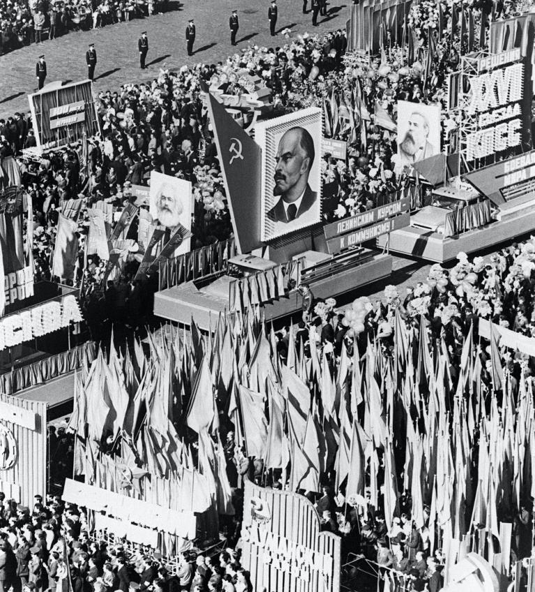 Φορτηγά μεταφέρουν το πορτρέτο του ιδρυτή του σοβιετικού κράτους Βλαντιμίρ Λένιν, κατά τη διάρκεια της παραδοσιακής πορείας στην Κόκκινη Πλατεία για τον εορτασμό της Πρωτομαγιάς στη Μόσχα, την 1η Μαΐου 1986. Ο κόσμος κρατά σημαίες και πορτρέτα του Καρλ Μαρξ και του Φρίντριχ Ένγκελς. [AFP]