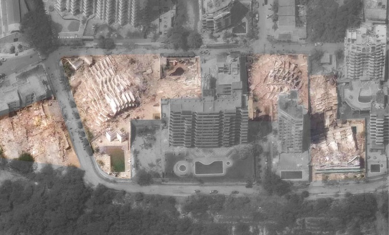 Nearby, in a planned neighborhood with hundreds of identical low-rise apartments, some buildings have completely collapsed, and many others sit wildly askew.