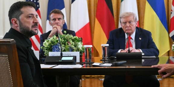 Ο Γάλλος πρόεδρος Εμανουέλ Μακρόν και ο Αμερικανός πρόεδρος Ντόναλντ Τραμπ ακούνε τον Ουκρανό πρόεδρο Βολοντίμιρ Ζελένσκι να μιλάει κατά τη διάρκεια συνάντησης με Ευρωπαίους ηγέτες στην Ανατολική Αίθουσα του Λευκού Οίκου στην Ουάσινγκτον, στις 18 Αυγούστου 2025. [ANDREW CABALLERO-REYNOLDS / AFP]